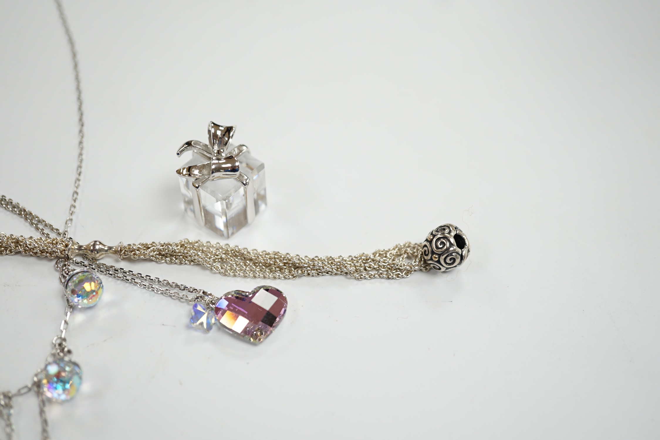 Two modern Swarovski crystal necklaces, a similar 'present' charm and a Pandora bracelet.